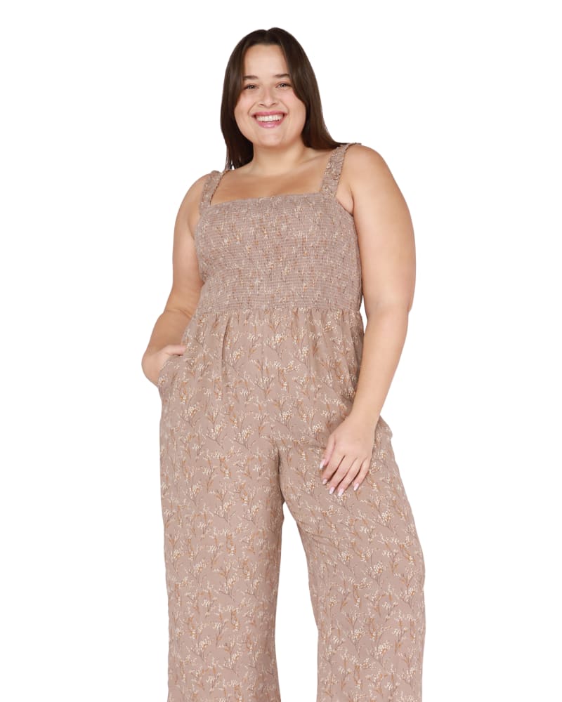 Front of a model wearing a size 0X Malia Smocked Wide Leg Jumpsuit in Taupe Floral by DEX PLUS. | dia_product_style_image_id:268476